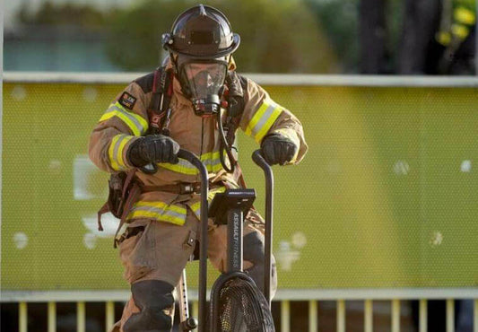Firefighter Erik Vidal training on the assault Bike - Photo by Captain Rick Stephens