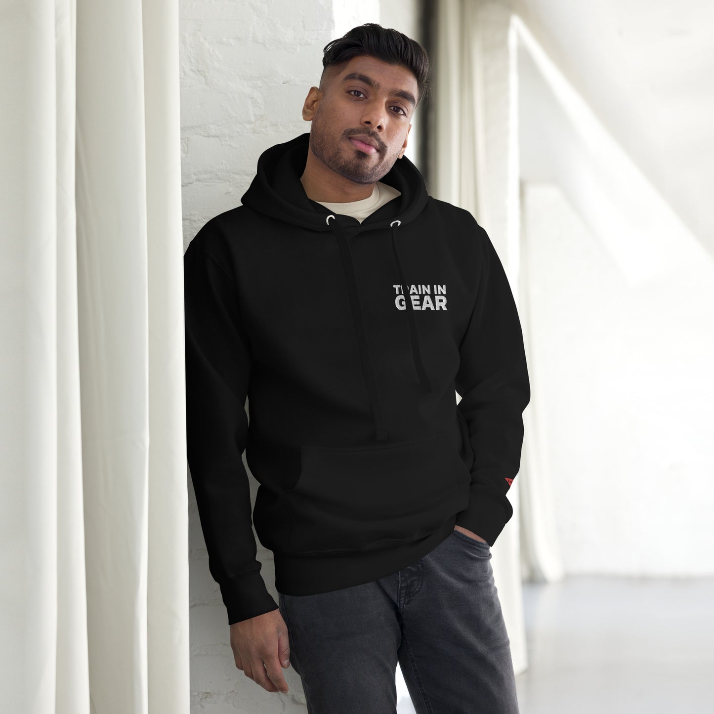 Train in Gear Embroidered Black Hoodie. Top left embroidery in white with our red uncivil spear embroidered on the left wrist.