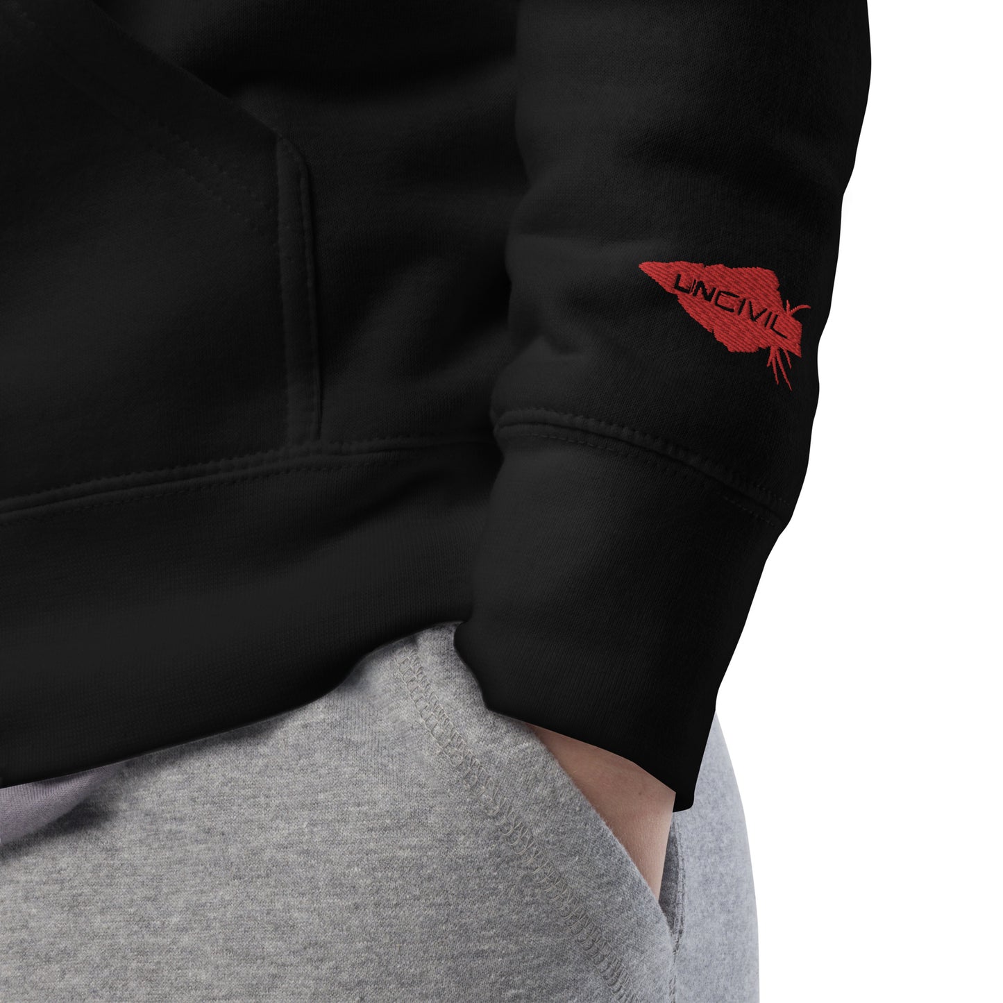 Train in Gear Embroidered Black Hoodie. Top left embroidery in white with our red uncivil spear embroidered on the left wrist.