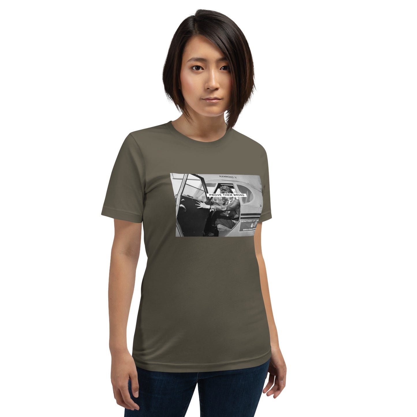 Prove Them Wrong graphic t-shirt features a graphic of Amelia Earhart on a plane in black and white. Army green shirt.