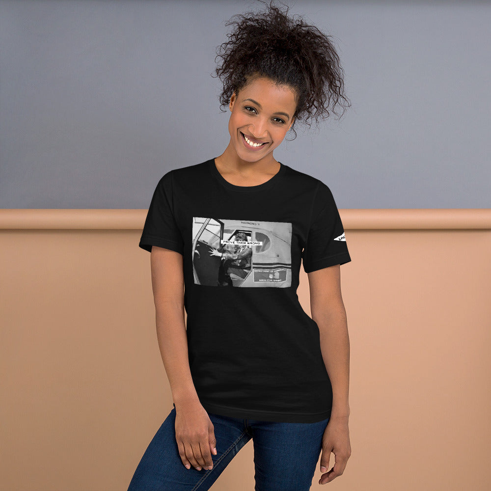 Prove Them Wrong graphic t-shirt features a graphic of Amelia Earhart on a plane in black and white.