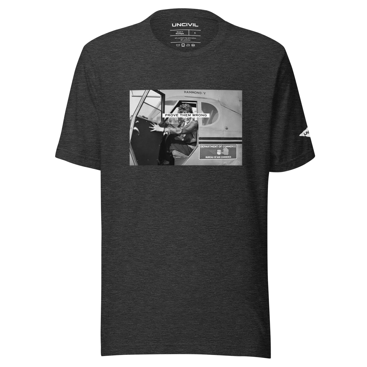Prove Them Wrong graphic t-shirt features a graphic of Amelia Earhart on a plane in black and white. Dark heather grey.