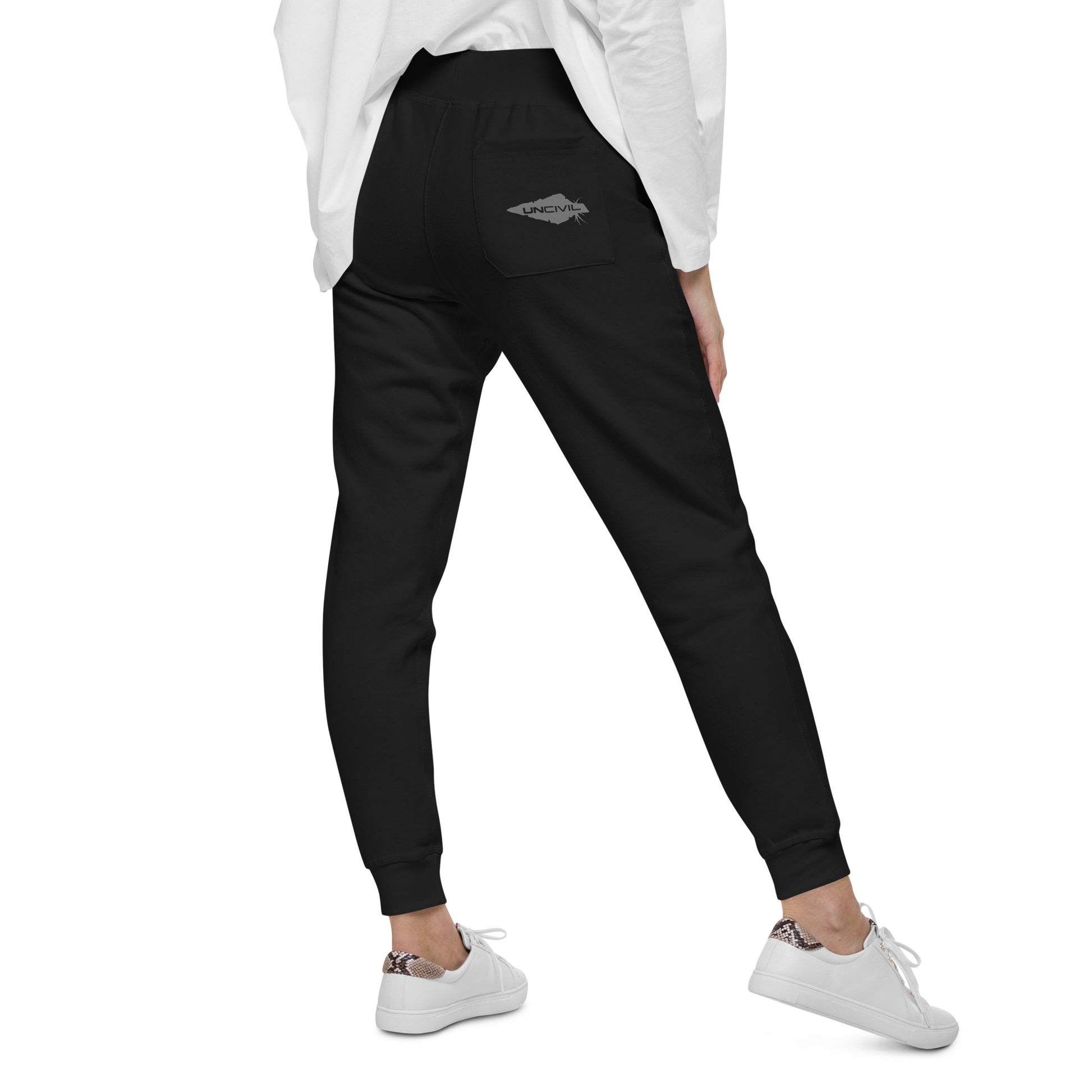 Black sweatpants, UNCIVIL on front left leg and UNCIVIL patch on the back right pocket.