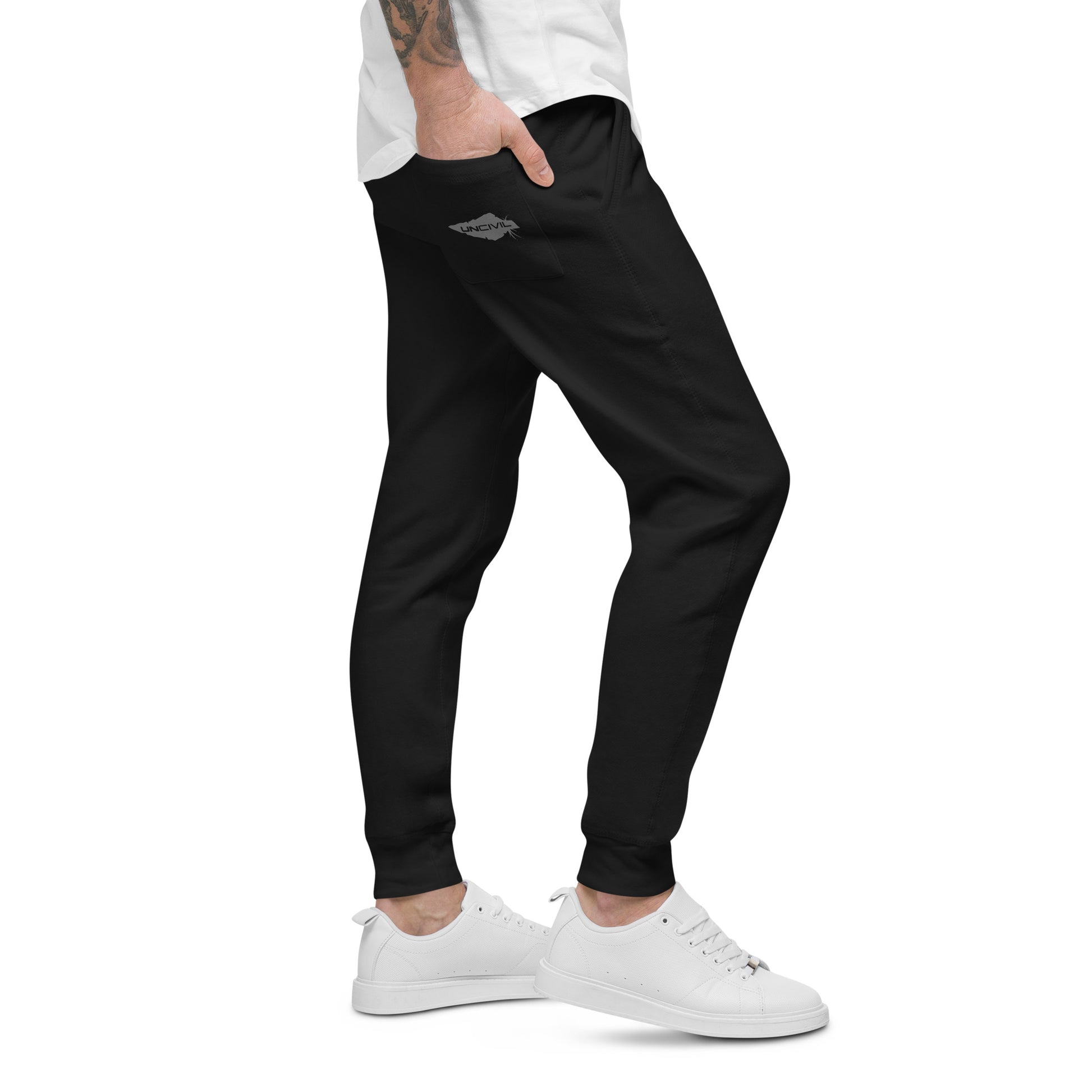 Black sweatpants, UNCIVIL on front left leg and UNCIVIL patch on the back right pocket.