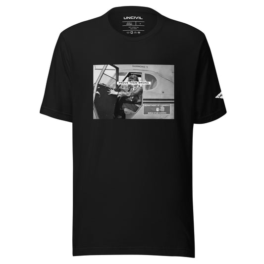 Prove Them Wrong graphic t-shirt features a graphic of Amelia Earhart on a plane in black and white. 
