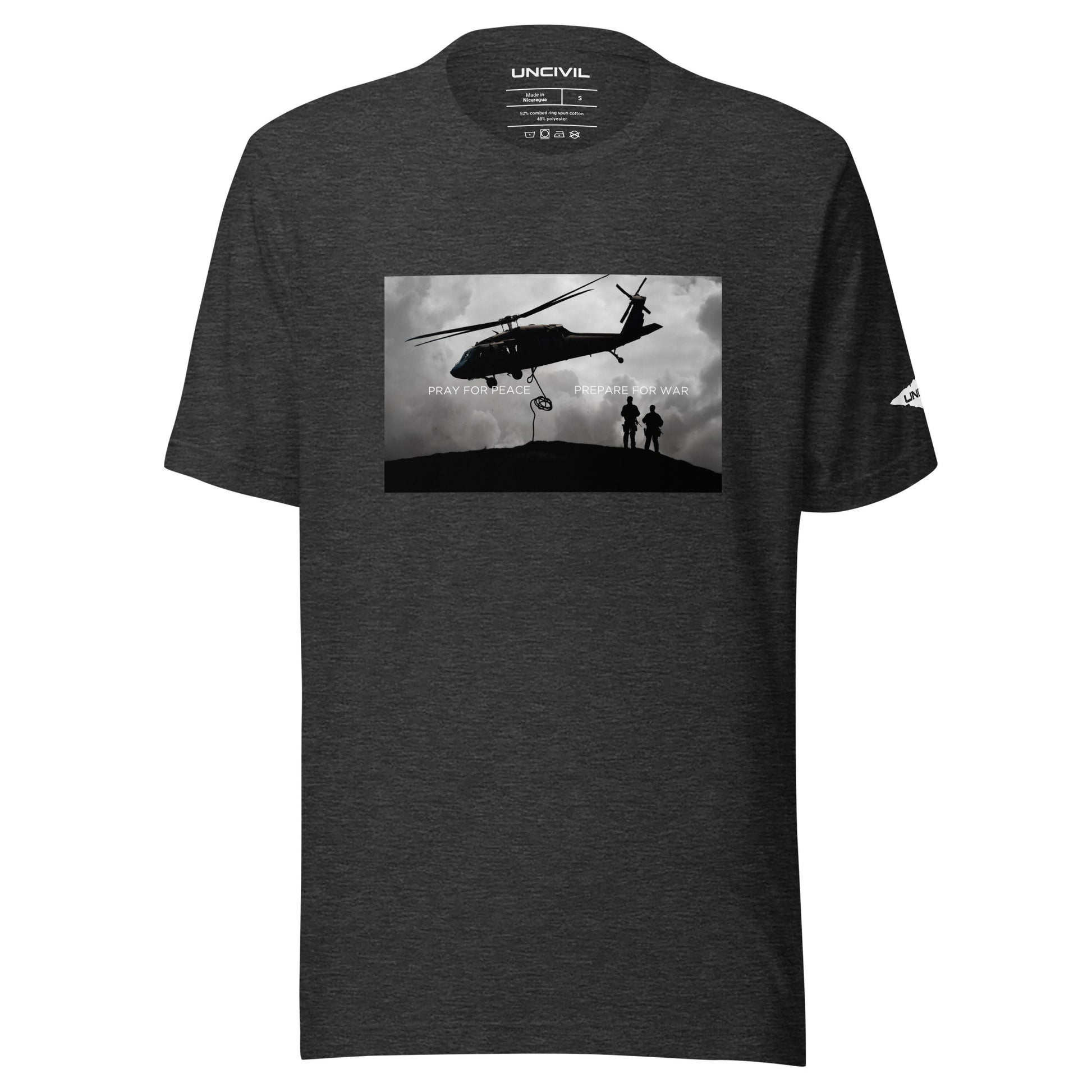 Our Prepare for War UNCIVIL shirt highlights the importance of both hoping for peaceful resolutions and being ready to defend oneself if necessary. Featuring a graphic of a Black Hawk Helicopter in black and white. Dark Grey shirt.