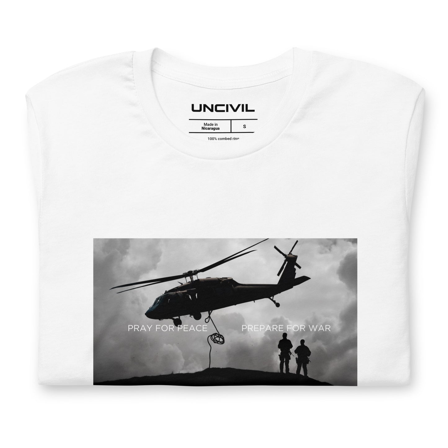 Our Prepare for War UNCIVIL shirt highlights the importance of both hoping for peaceful resolutions and being ready to defend oneself if necessary. Featuring a graphic of a Black Hawk Helicopter in black and white. White shirt.